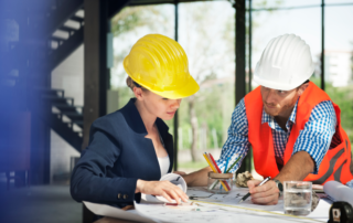 Engineers reviewing plans for domestic elevators.